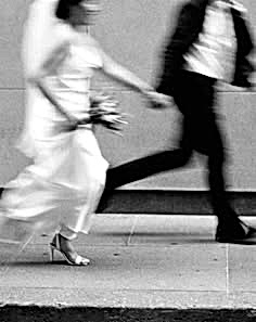 newly married couple running