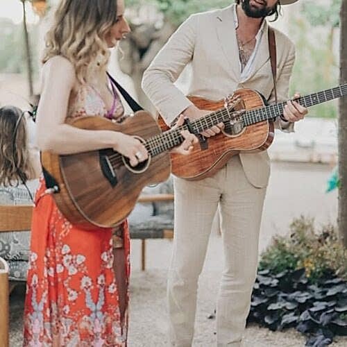 two musicians playing acoustic guitars