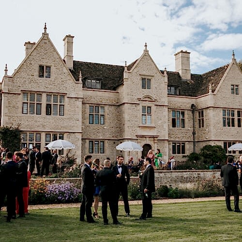 outside view of wedding venue with people in suits and dresses