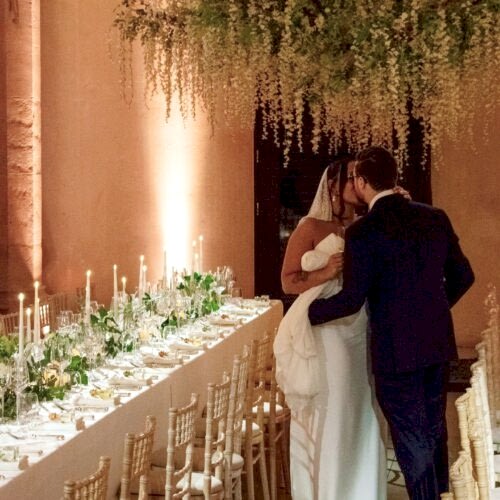 married couple standing by their dining table