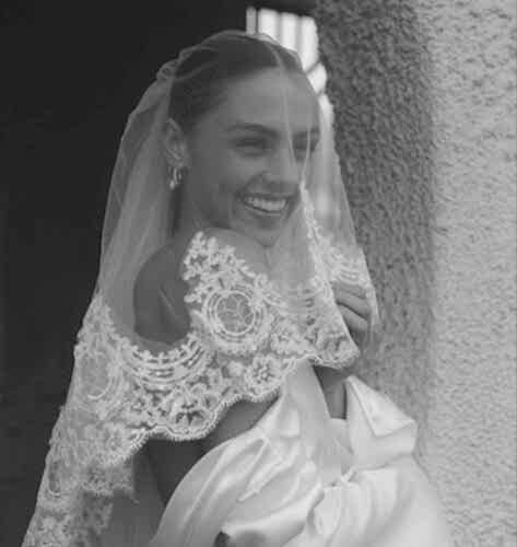 women smiling underneath wedding veil