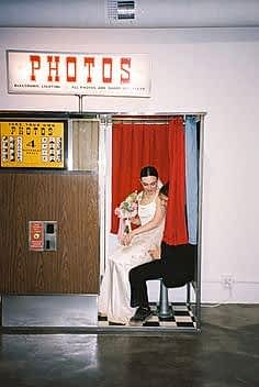 newly married couple sitting in a Photo Booth