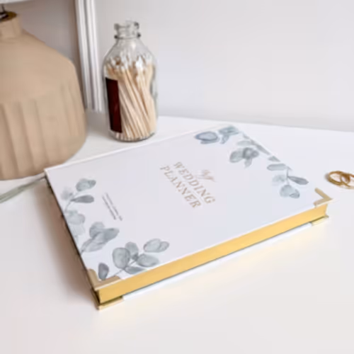 outside cover of white, green and gold wedding planner