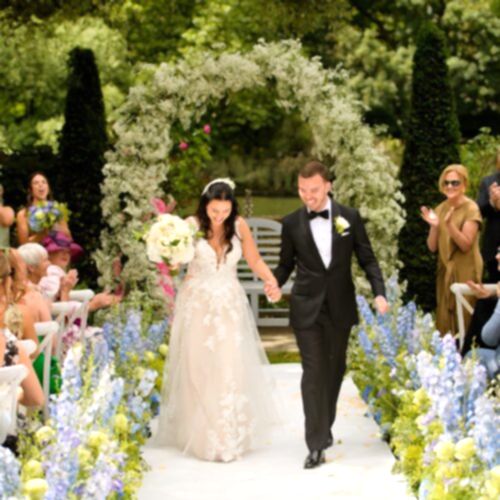 A newly married couple walking down the aisle.