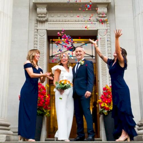 confetti being thrown on couple during wedding ceremony