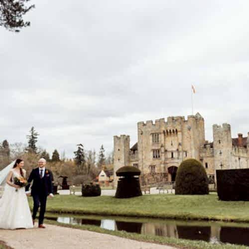 Newly married couple walking around the grounds of Hever Castle