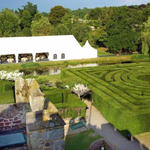 A view of the gardens and maze with tent used for outdoor wedding venue space
