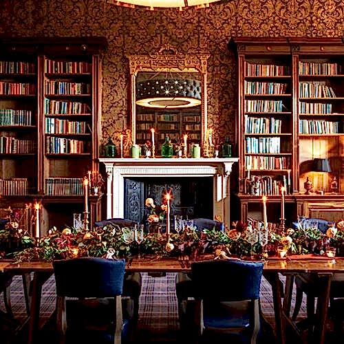 Indoor wedding dining space with fireplace and bookshelves.