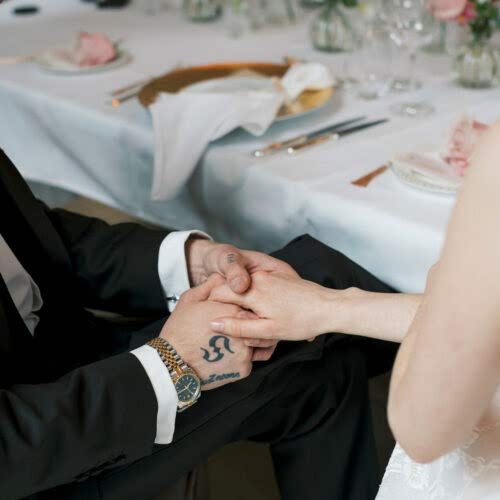 Newly married couple holding hands