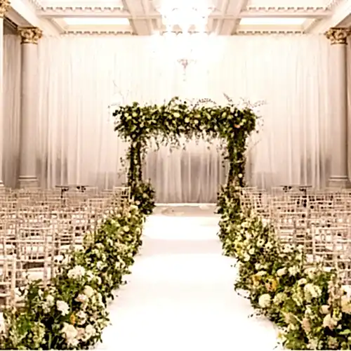 Wedding ceremony event space decorated with flower arrangements