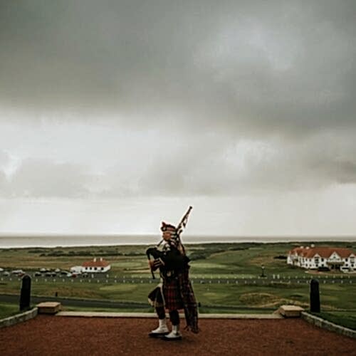 Man playing the bagpipes with an aesthetic backdrop